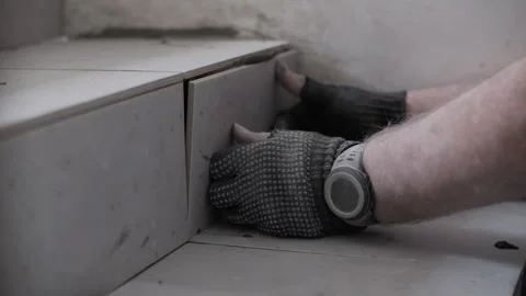 Worker installing tile on stair Stock Footage 311881926