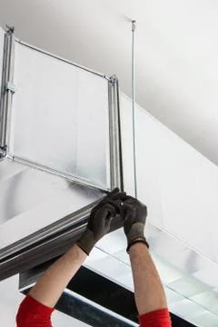 Worker Installing an Vent Duct Stock Photos