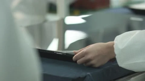 Worker installs and checks lcd matrix for tv on factory assembly line Video stock 162367537