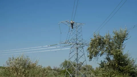 Worker installs aviation marker ball on wires of power lines Video stock 149651073