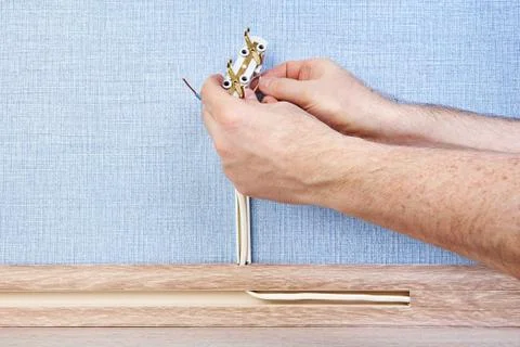 Worker installs electrical socket. 写真素材