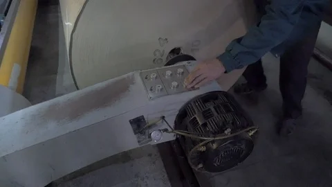 Worker installs a large roll of wrapping paper in the machine Stock Footage 113789024