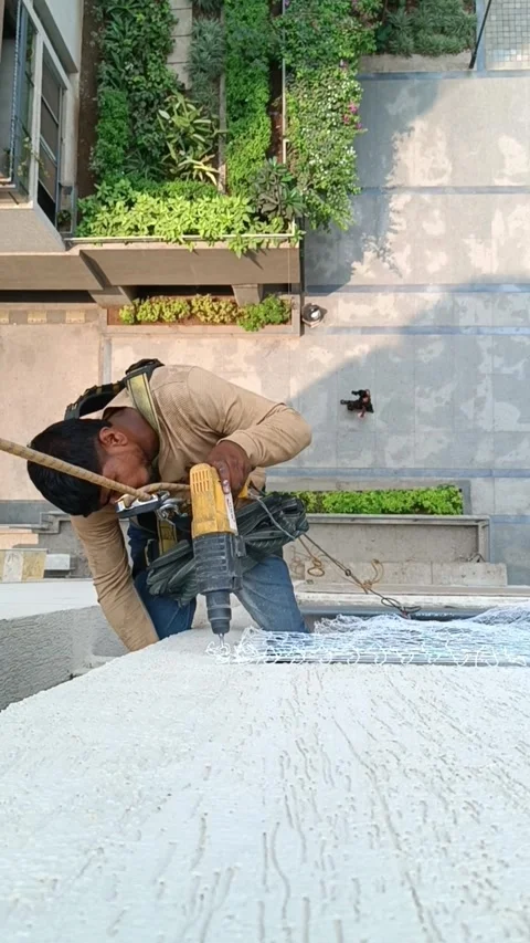A worker installs a pigeon net at the balcony of a high-rise building Stock Footage 305453797