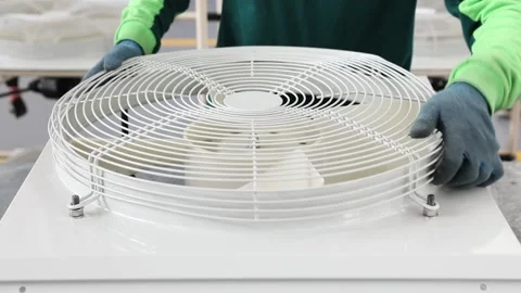 Worker installs a protective mesh on the ventilation system Stock Footage 162904066