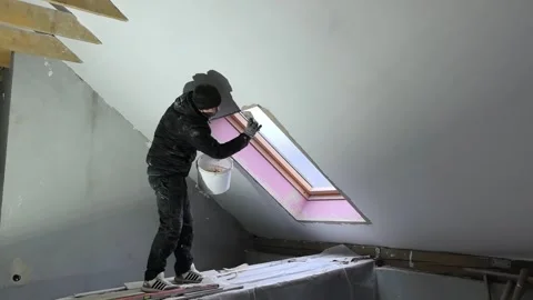 Worker installs window in attic during renovation project in residential house Stock Footage 329906256