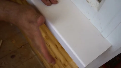 A worker installs a window sill in the loggia Stock Footage 77828800