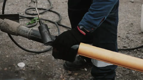 A worker insulates a joint between two plastic pipes. Stock Footage 318268176