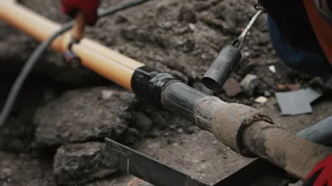 A worker insulates a joint between two plastic pipes. Stock Footage 318268191