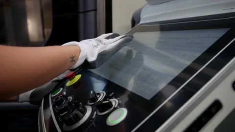 Worker Interacting with a Touchscreen CNC Control Panel Stock Footage 318304101