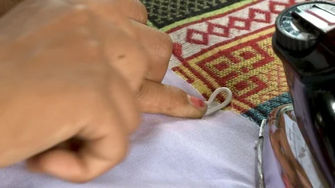 A worker ironing a piece of string into a cloth Stock Footage 119997958