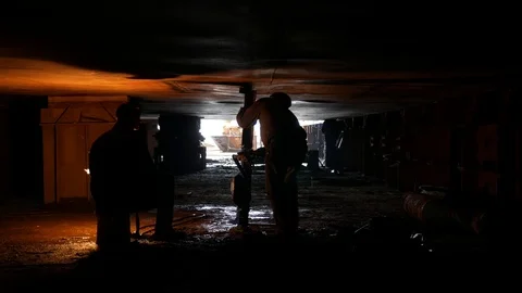 A worker with a jack supports the surface, the welder is working Video stock 87453572