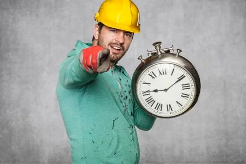 Worker keeps the clock and points to you Foto stock