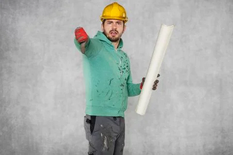 The worker keeps the plans in hand, thumbs down Stock Photos