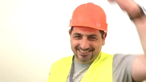 The worker knocks on the helmet in his head Stock Footage 93306755