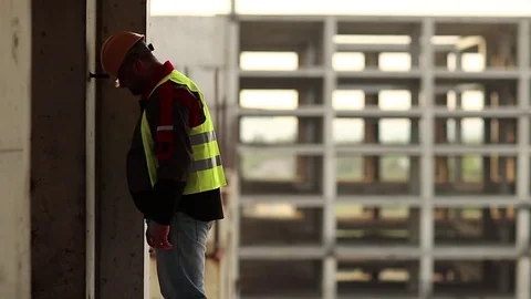 Worker knocks his head against the wall Stock Footage 83398192