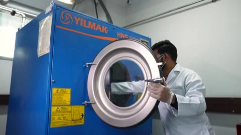 Worker In A Lab Performing Chemical Testing On Textile Products Using An Stock Footage 333913682
