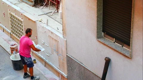 Worker labor building wall and UPVC groove line with plaster cement at house 스톡 동영상 114355872