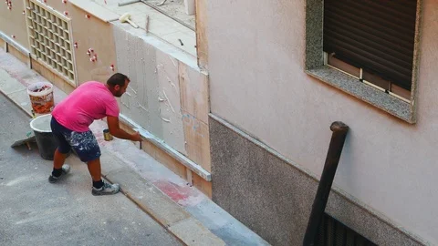 Worker labor building wall and UPVC groove line with plaster cement at house 動画素材 114606379