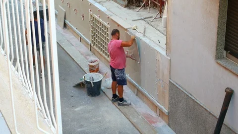 Worker labor building wall and UPVC groove line with plaster cement at house 動画素材 125852897