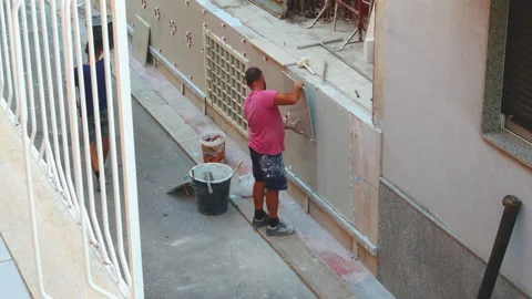 Worker labor building wall and UPVC groove line with plaster cement at house 動画素材 137226098