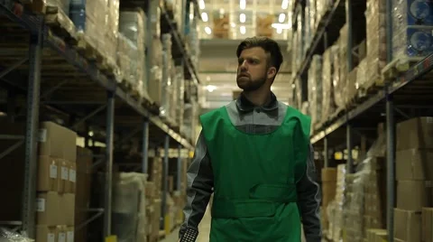 The worker is to a large warehouse with a terminal in the hand Stock Footage 64046700