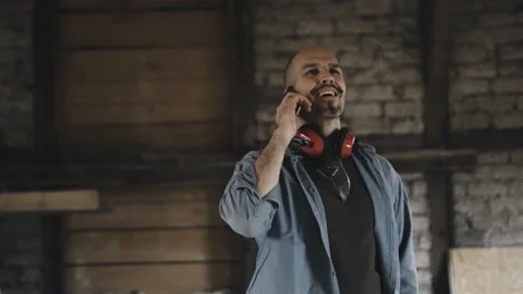 Worker laughing on a phone call Stock Footage 149293122