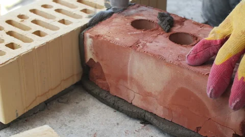 Worker laying brick on mortar at construction site Stock Footage 314644981