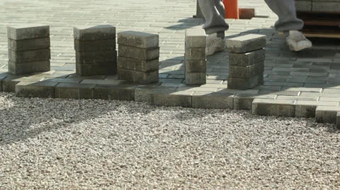 Worker laying brick tiles on the road 스톡 동영상 23538328