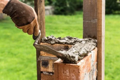 A worker is laying a brick wall. Stock Photos