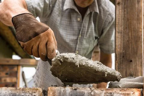 A worker is laying a brick wall. Stock Photos