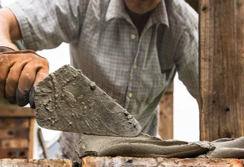 A worker is laying a brick wall. Stock Photos