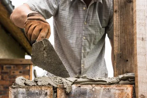 A worker is laying a brick wall. Stock Photos