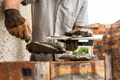 A worker is laying a brick wall. Stock Photos