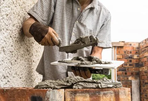 A worker is laying a brick wall. Stock Photos