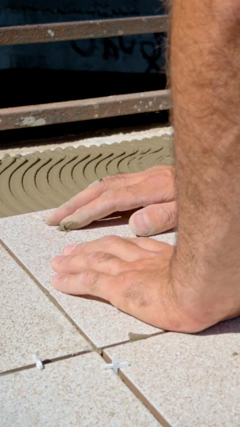 Worker laying ceramic tile on floor close up Stock Footage 329308564