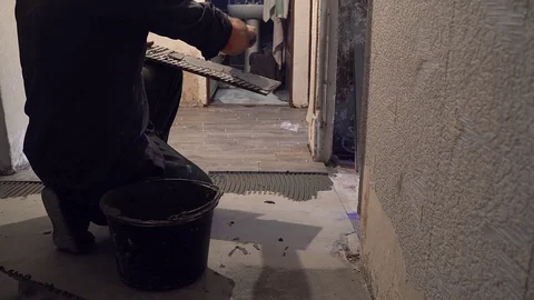 Worker laying ceramic tiles on the floor Stock Footage 108177400