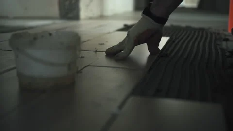 Worker laying ceramic tiles on floor Stock Footage 279020016
