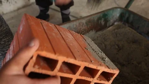 Worker laying down the brick over concrete Stock Footage 75773795