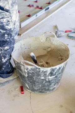Worker laying floor tiles during home renovation project Stock Photos