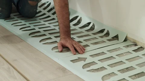 Worker Laying Foam Underlayment Sheets on Floor Stock Footage 322055760