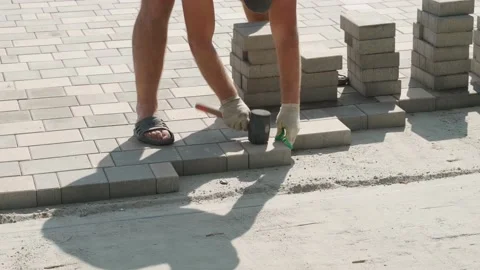 Worker laying paving slabs. We work with a rubber hammer. Close-up. Sound Stock Footage 145151739