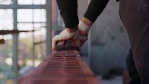 Worker laying red bricks for masonry wall construction Stock Footage 346551292