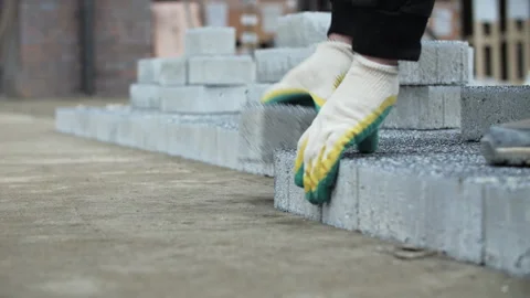 Worker laying sidewalk paving stone layer by hand Stock Footage 326064621