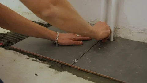 Worker laying tiles on floor Video stock 128414732