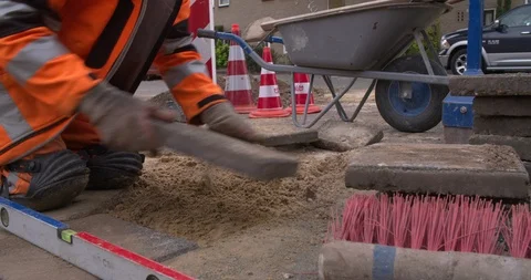Worker laying tiles at sidewalk of Netherlands street Stock Footage 95633089