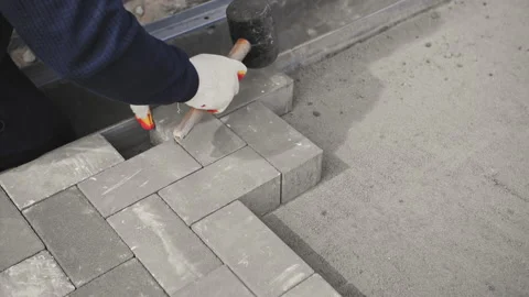 Worker lays new paving slabs Stock Footage 237335830