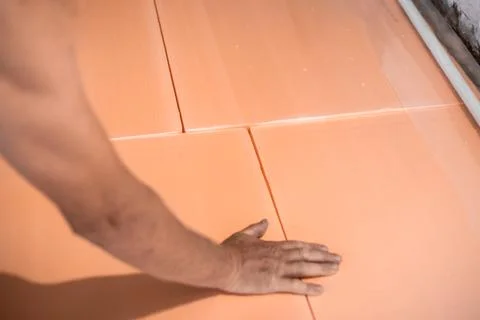 Worker lays polystyrene foam on the floor. Insulation of the house, install.. Stock Photos