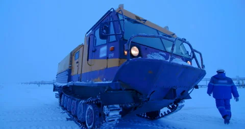 Worker leaves the tracked all-terrain vehicle and goes to work Stock Footage 105989022