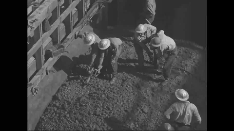Worker level the cement to construct the Grand Coulee Dam - 1938-1939 Stock Footage 103595015