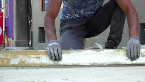 Worker level the sand for paving slabs Stock-Footage 89154735